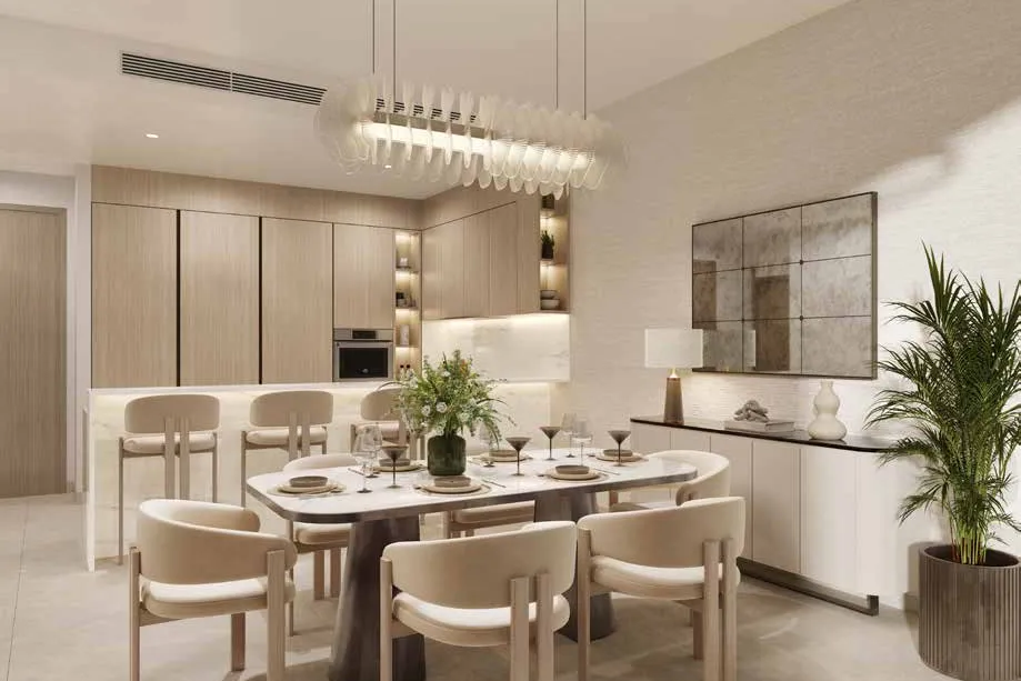 Dining table beside a wood-panelled kitchen with breakfast bar