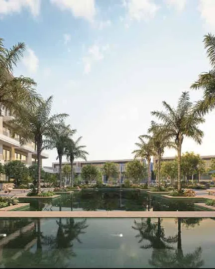 Still courtyard pool reflecting palms between the residential wings