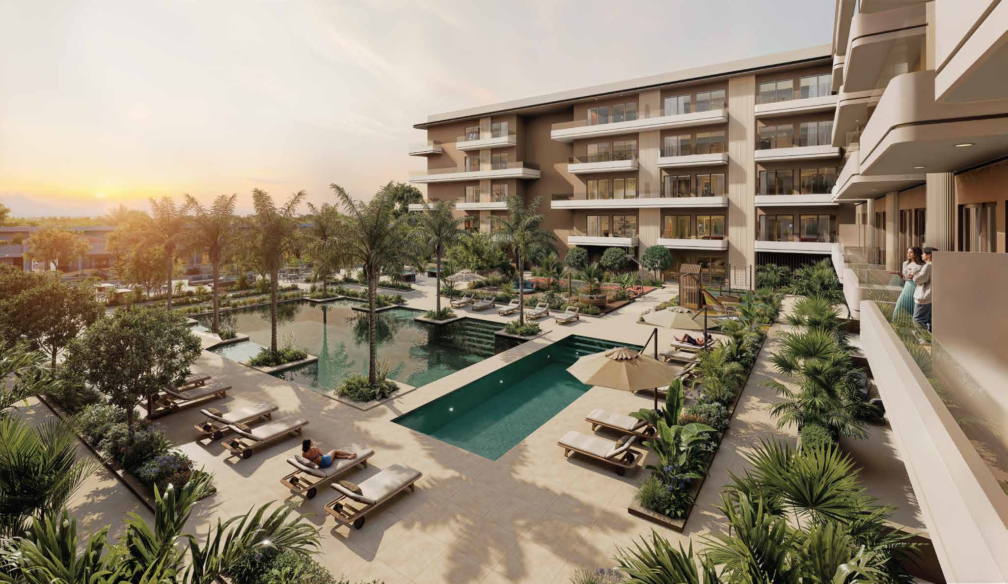 Palm-lined courtyard pools and loungers at sunset beside the residences